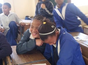 Schoolgirls laughing in a classroom