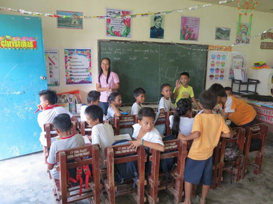 Schoolkids and a teacher in a Philippines classroom