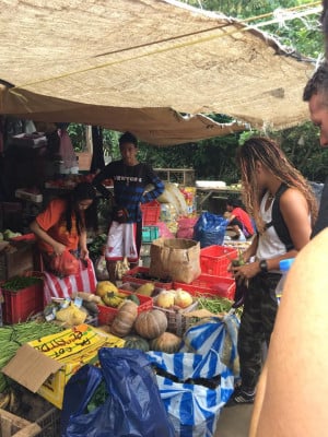Travellers browsing a market stall