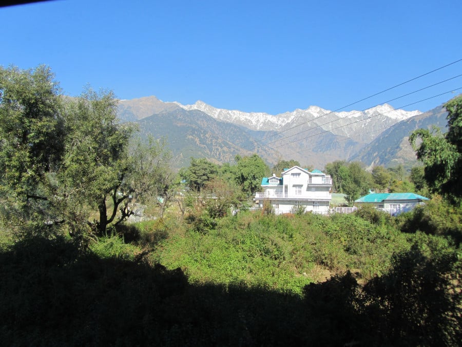 A large house with Himalayan mountains in the background