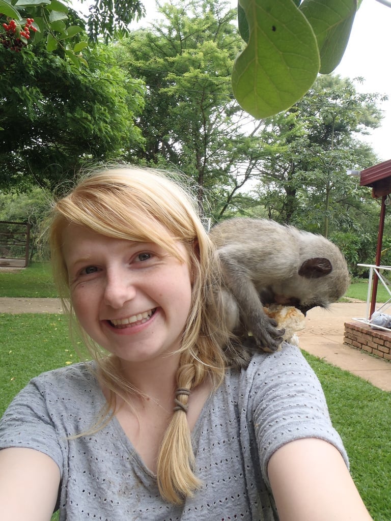 Jenny McLarney in South Africa with a monkey on her shoulder