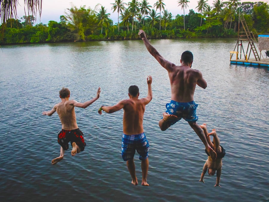 People jumping into water