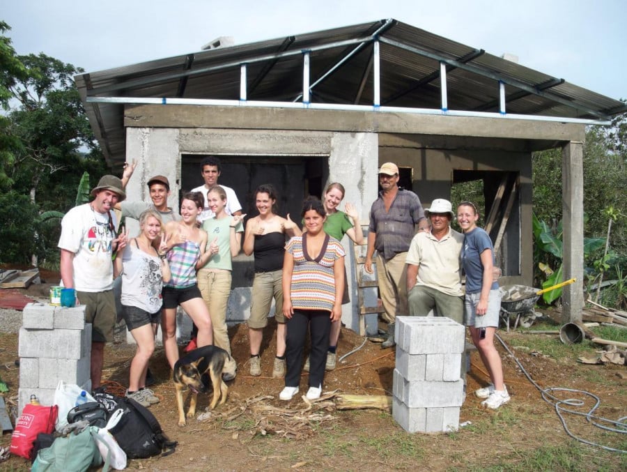 Volunteers standing at a building site