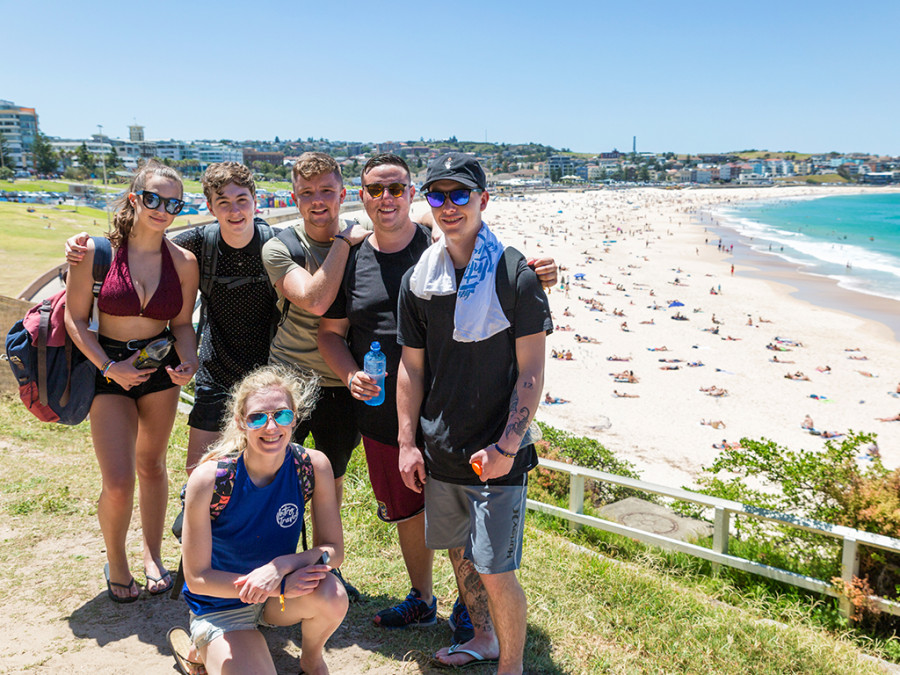 A group of travellers on a Sydney beach