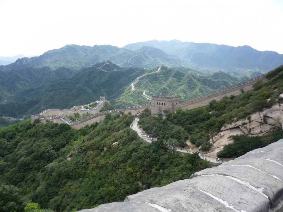 The Great Wall of China and surrounding densely forested mountains