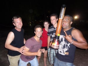 A group of people with one holding a large firework