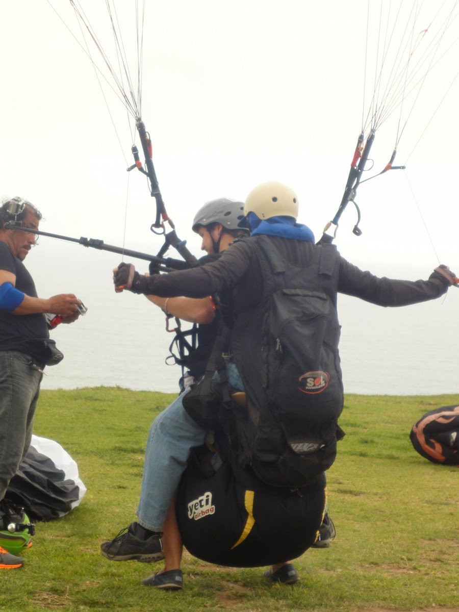 People preparing to tandem paraglide