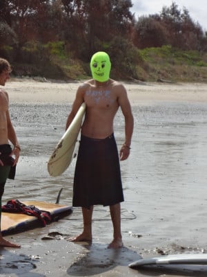 A surfer in a bright green mask