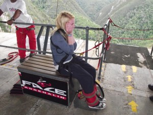 Jenny sitting with her face in her hands preparing herself to bungee jump