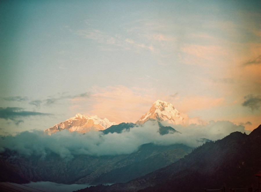 Misty Himalayan mountains with a pink and blue sky