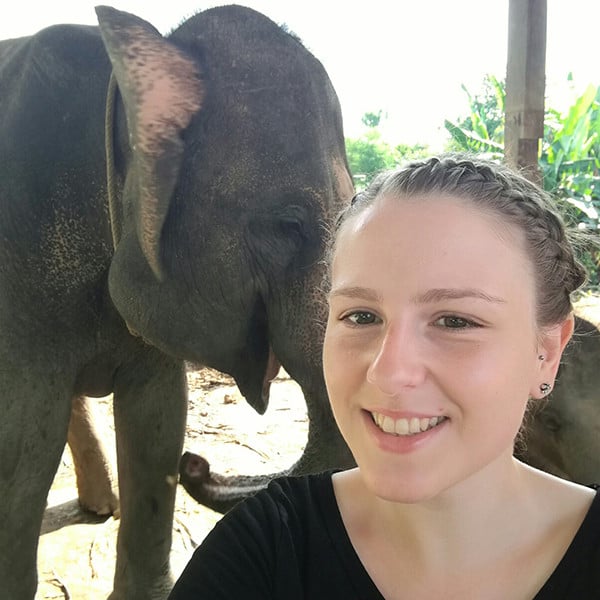 Kayleigh taking a selfie with an elephant in the background