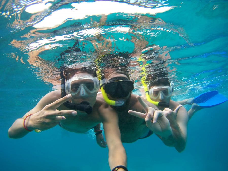 Travellers underwater in snorkelling gear