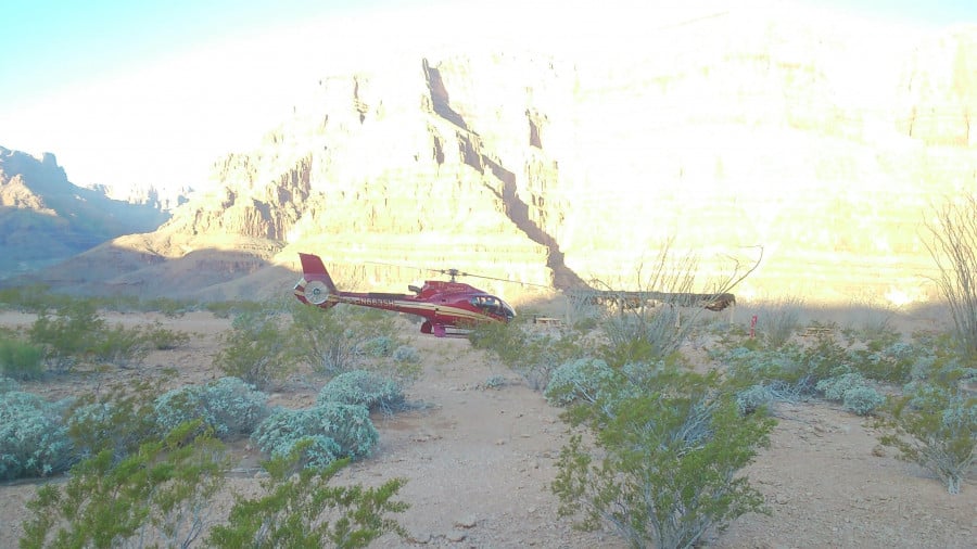 A red helicopter in the Grand Canyon
