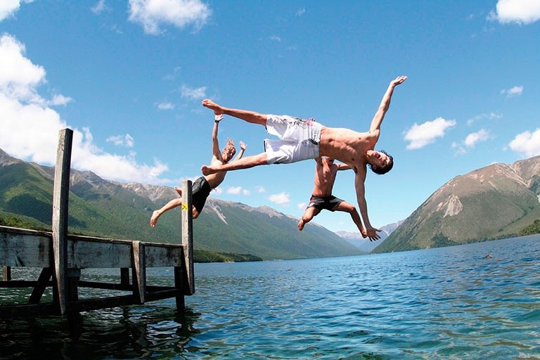 Three guys jumping into lake Rotorua