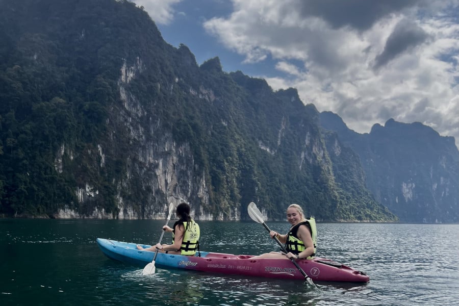 Travellers canoeing in water between islands