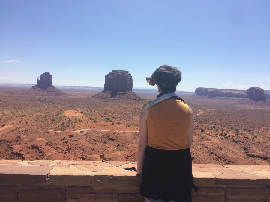 A lady looking out at rock formation in Monument Valley, USA