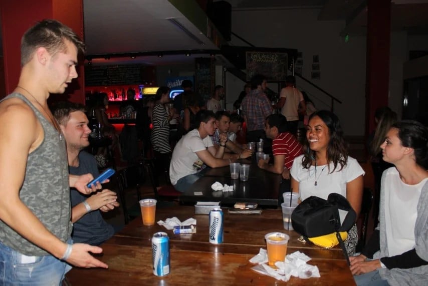 Travellers drinking in a hostel bar