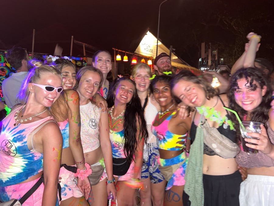 Group of travellers on Haad Rin Nok beach at the Full Moon Party