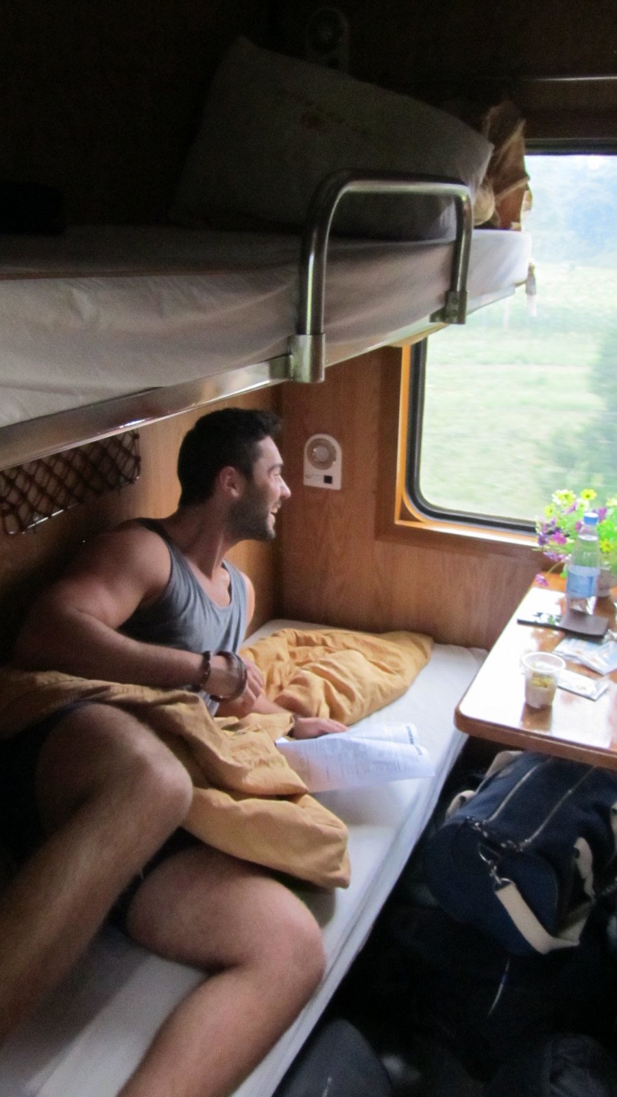 A man on a bed on a train