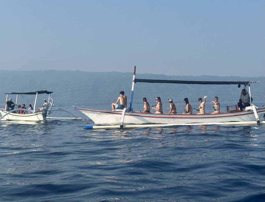 Group travellers on boat near Lovina Beach in Bali