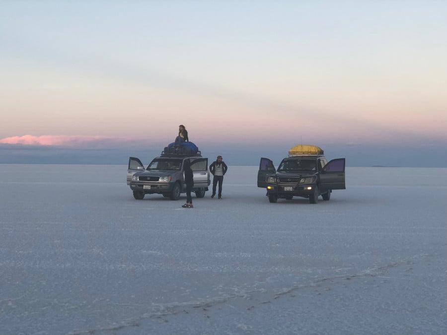 Travellers in 4x4 vehicles in Salar de Uyuni exploring the Salt Flats in Bolivia 