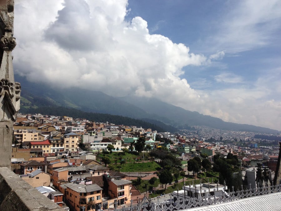 The city of Quito in Ecuador, with volcanoes and clouds in the background