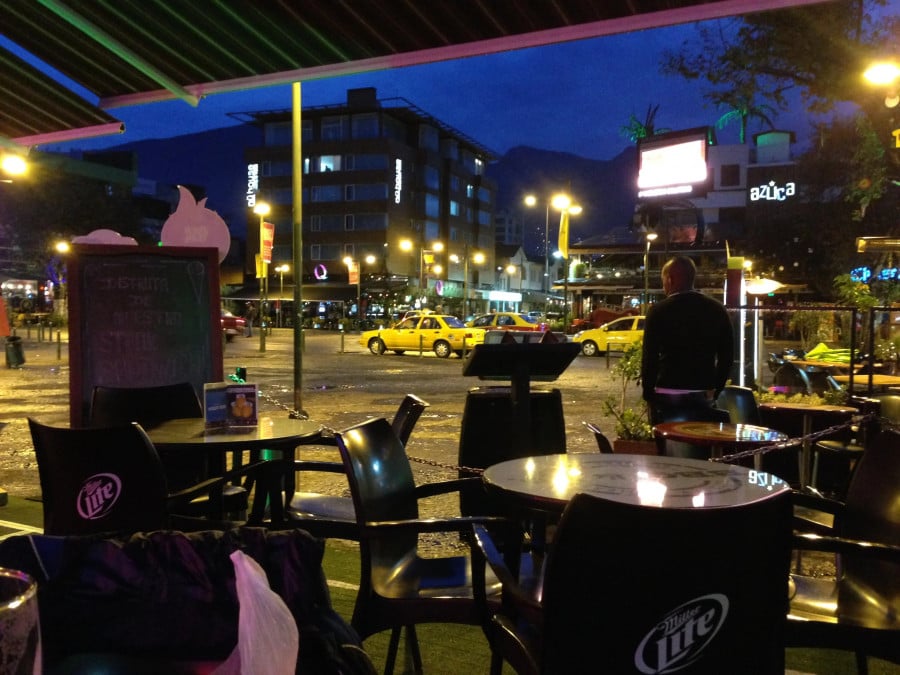 A bars outdoor seating area at night