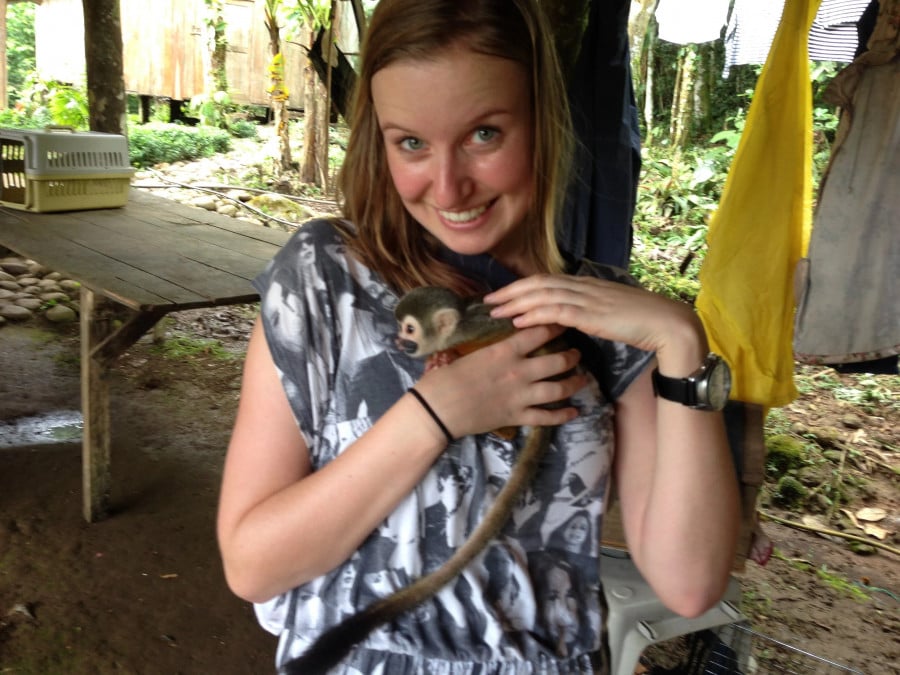 A volunteer holding a small monkey