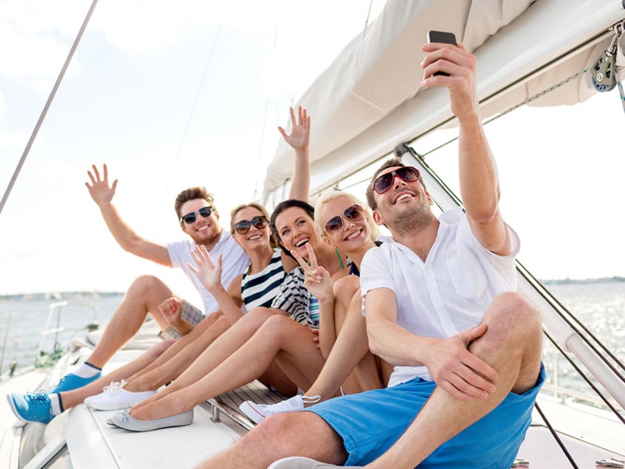 A group of travellers on a boat taking a selfie