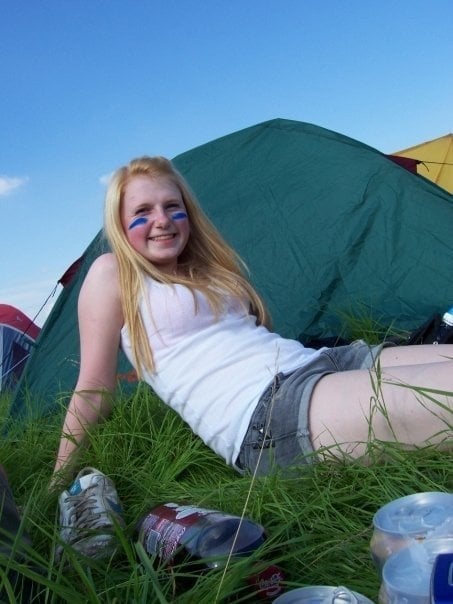 jenna sitting on the grass in front of a tent