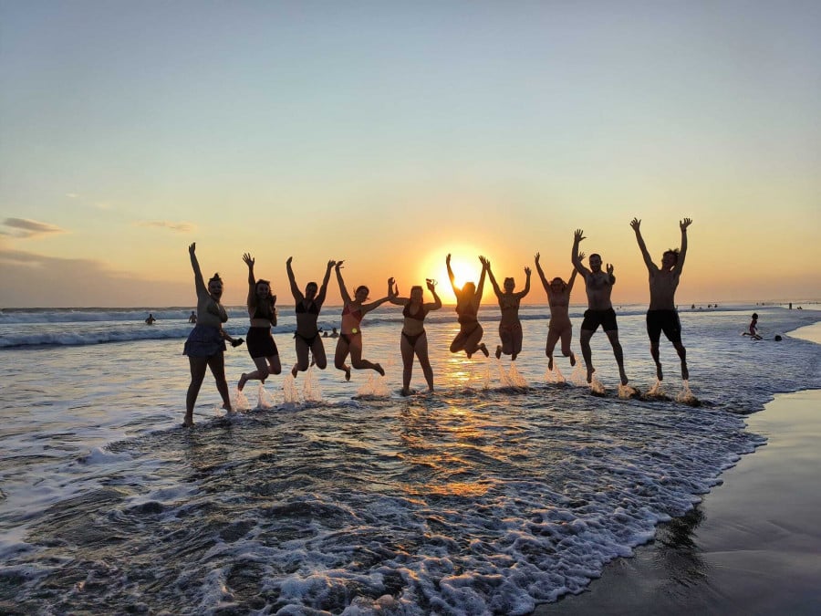 Group jumping in front of sunset in Bali Seminyak 