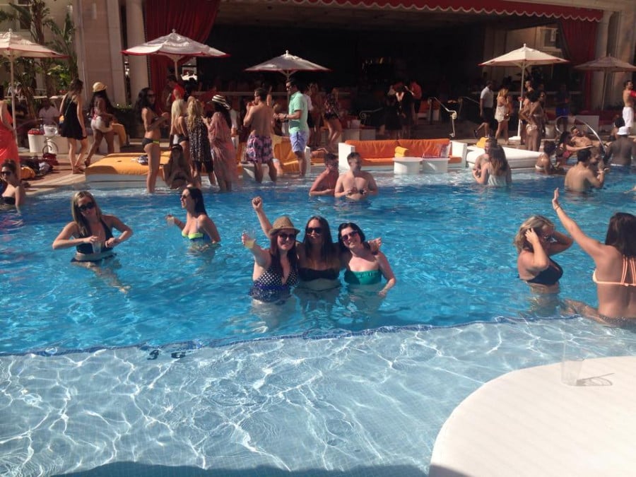 People drinking and swimming in a pool at a bar in Las Vegas