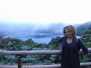 Shakia with lush greenery and a misty lake in the background