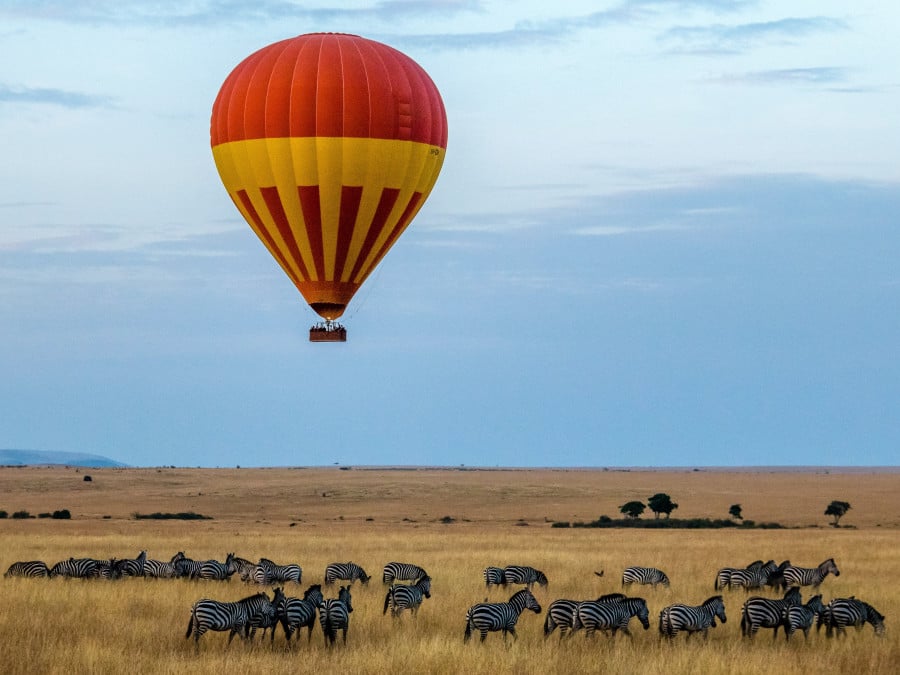 Hot air balloon flying over Zebras in Kenya