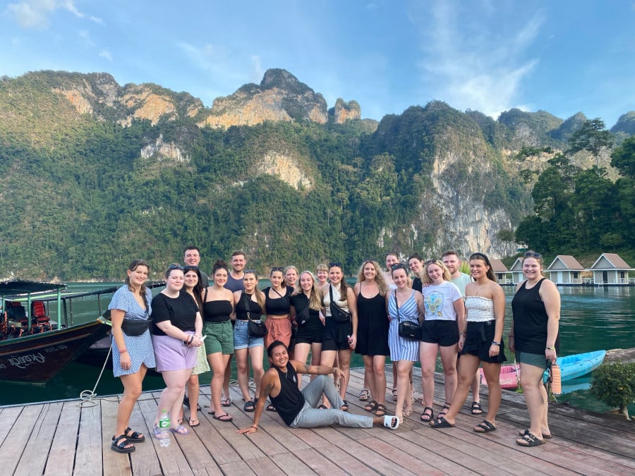 Group of travellers on a group tour, stopping off at Khao Sok National to stay in floating bungalows in Thailand