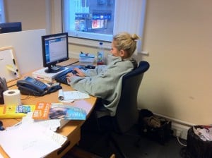 A gap 360 staff member wearing winter clothes while at their desk