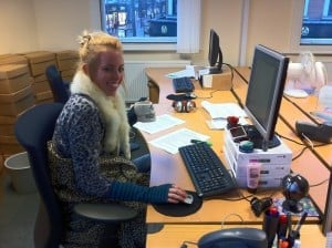 A Gap 360 staff member wearing a scarf at her desk