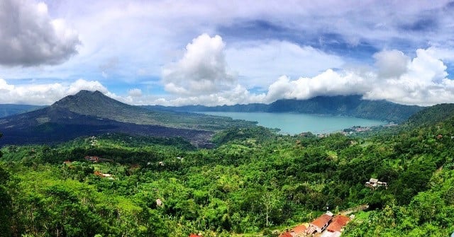 An aerial view of forest, mountains and river in Ubud