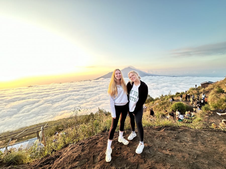 Travellers at the top of Mount Batur in bali at sunrise